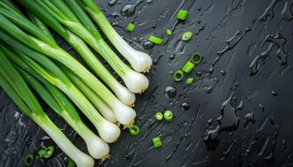 Wall Mural - Fresh green spring onions with water drops as background, top view