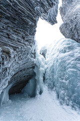 Ice cave with rock formation of water eroded on winter