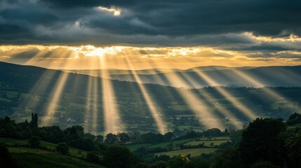 Sticker - A breathtaking landscape with sun rays piercing through clouds over rolling hills.