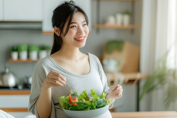 A beaming woman mixes a colorful salad, savoring the moment of enjoying fresh, healthy ingredients in her cozy kitchen.