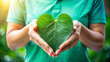 © PuriStudio - A person holds large green leaf shaped like heart, symbolizing love for nature and sustainability. This image represents importance of renewable resources and environmental care