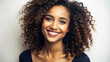 © PuriStudio - A close up studio shot of beautiful young mixed race woman with curly hair, showcasing her radiant smile and joyful expression