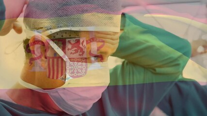 Poster - Animation of flag of spain over caucasian surgeons wearing face masks