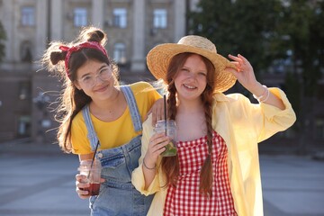 Happy teenage friends posing on city street