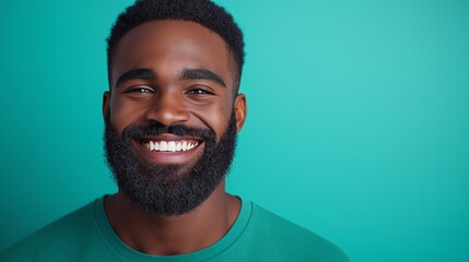 Canvas Print - A man with a beard is smiling and looking at the camera. The image has a happy and friendly mood