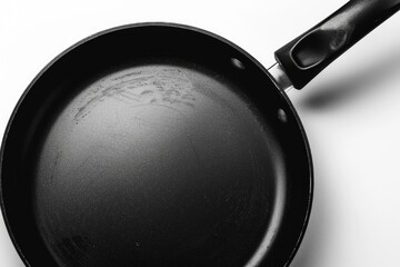 Poster - A black frying pan placed on a white surface, ready for use