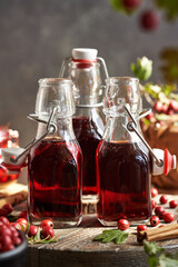 Wall Mural - Three bottles of medicinal wine made of fresh hawthorn berries and spices