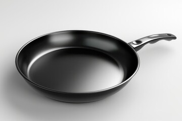 Poster - A close-up shot of a black frying pan on a white surface, ready for cooking