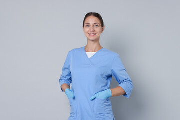 Poster - Nurse in medical uniform on grey background