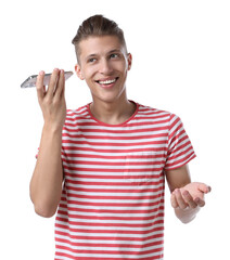 Poster - Young man with smartphone listening to voice message on white background