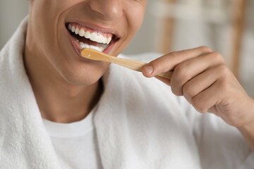 Canvas Print - Young man brushing his teeth in bathroom, closeup