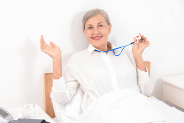 Sticker - Happy senior woman with emergency call button in hospital