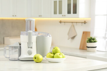 Wall Mural - Modern juicer and apples on white marble table in kitchen, space for text