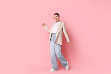 Canvas Print - Stylish woman in beige jacket and jeans on pink background