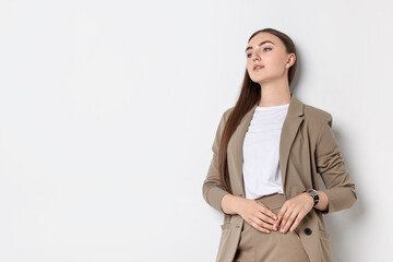 Canvas Print - Beautiful woman in beige suit on white background, space for text