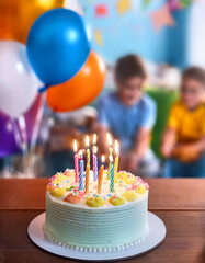 empty table with copy space, with birthday cake in the background children playing at birthday party indoors, with balloons and inflatables
