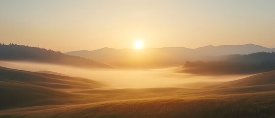 Fototapete - Serene sunrise breaking through the hazy morning fog over a picturesque rolling countryside landscape with mountains silhouetted against the glowing sky  A tranquil
