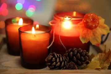 Wall Mural - Burning candles and autumn decor on tray, closeup