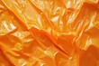 © Nadia Do - Orange crumpled plastic bag texture, abstract background