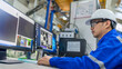 © reewungjunerr - Computer engineers developing software programs to control industrial machinery,optimizing automation processes,and improving production flow in a high-tech factory setting
