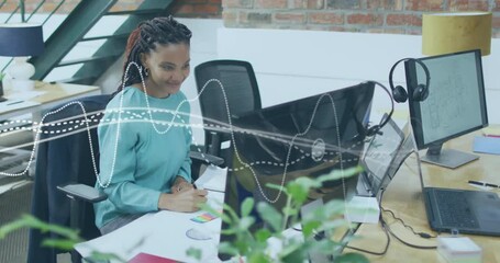 Poster - Animation of diagram over biracial businesswoman using computer in office