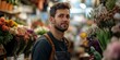© Irina Ukrainets - A man stands confidently in a vibrant flower market. Surrounded by colorful blooms, he reflects the joy of nature and passion for floral design. Perfect for showcasing creativity and beauty. AI