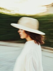 Motion Blur of Woman in Beige Hat in Sunny Garden