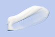 © tatyanarow - White cream balm swatch isolated on forget me not blue color