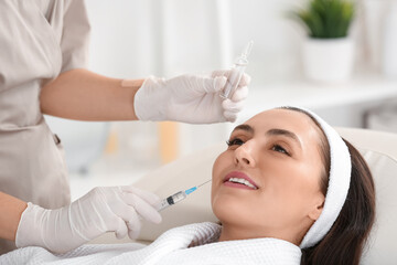 Wall Mural - Beautiful young woman receiving injection in beauty salon, closeup