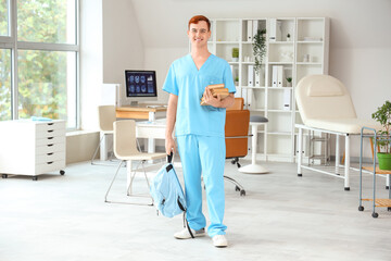 Wall Mural - Male medical student with books in clinic