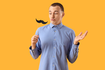 Sticker - Funny young man with paper mustache on yellow background