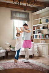 Wall Mural - Dance, ballet and father with daughter in living room for celebration, happy or energy. Music, princess and trust with man and helping young girl in family home for support, learning or holding hands