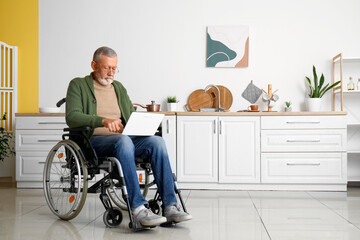 Sticker - Senior man in wheelchair using laptop at home