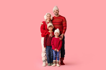 Canvas Print - Happy family with children in winter clothes on pink background