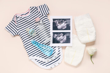 Sticker - Composition with baby clothes, sonogram images, diapers and bottles of cosmetic products on pink background