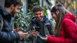 © fotofabrika - Young friends enjoying a lively moment outdoors while sharing messages on their smartphones during a sunny afternoon in the city