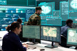 © DC Studio - Military IT experts working on cyber security in a high tech government office. Focusing their duty on network protection, encryption and safeguarding state secrets from digital mercenaries.
