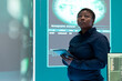 © DC Studio - Woman IT specialist launches phishing attack to steal passwords and personal data for cyberwarfare tactics. Operating on tablet and big screen to penetrate a database in monitoring room.