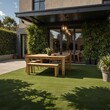 © JohnDesignHub - Outdoor patio with wooden table and benches, surrounded by plants.