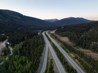 Wall Mural - Scenic Aerial View of Highway Through Forested Mountains in British Columbia, Canada at Dusk