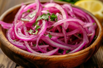 Close up of red onion salad in wooden bowl with parsley and lemon garnish