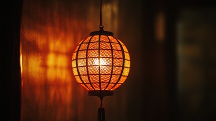 A glowing orange lantern hanging in a dark room, casting warm light and shadows around.