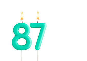 Wall Mural - Birthday number 87 - Green birthday candle on white background