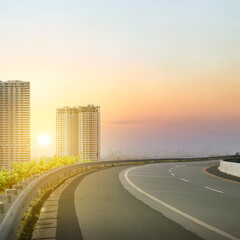 A road with a sunset in the background and a city skyline in the distance