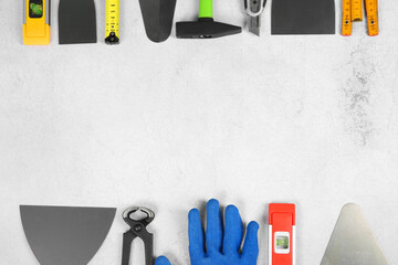 Poster - Many different construction tools on light textured table, flat lay. Space for text