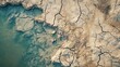 © นิโลบล ชํานาญธรรม - An aerial view of an expansive, barren reservoir, with water levels drastically low, revealing the cracked earth beneath, portraying the severity of the global water shortage crisis