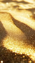 Close-up of golden shimmering sand with bokeh effect, sparkling texture. Abstract luxury and elegance concept