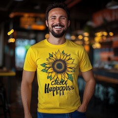 Wall Mural - Man in yellow shirt with sunflower graphic smiling.