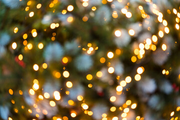 Defocused orange lights background. Festive lights as symbol of coming Christmas and New Year. Backdrop for your design