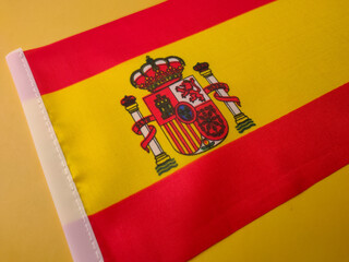 Closeup spain flag on a yellow background